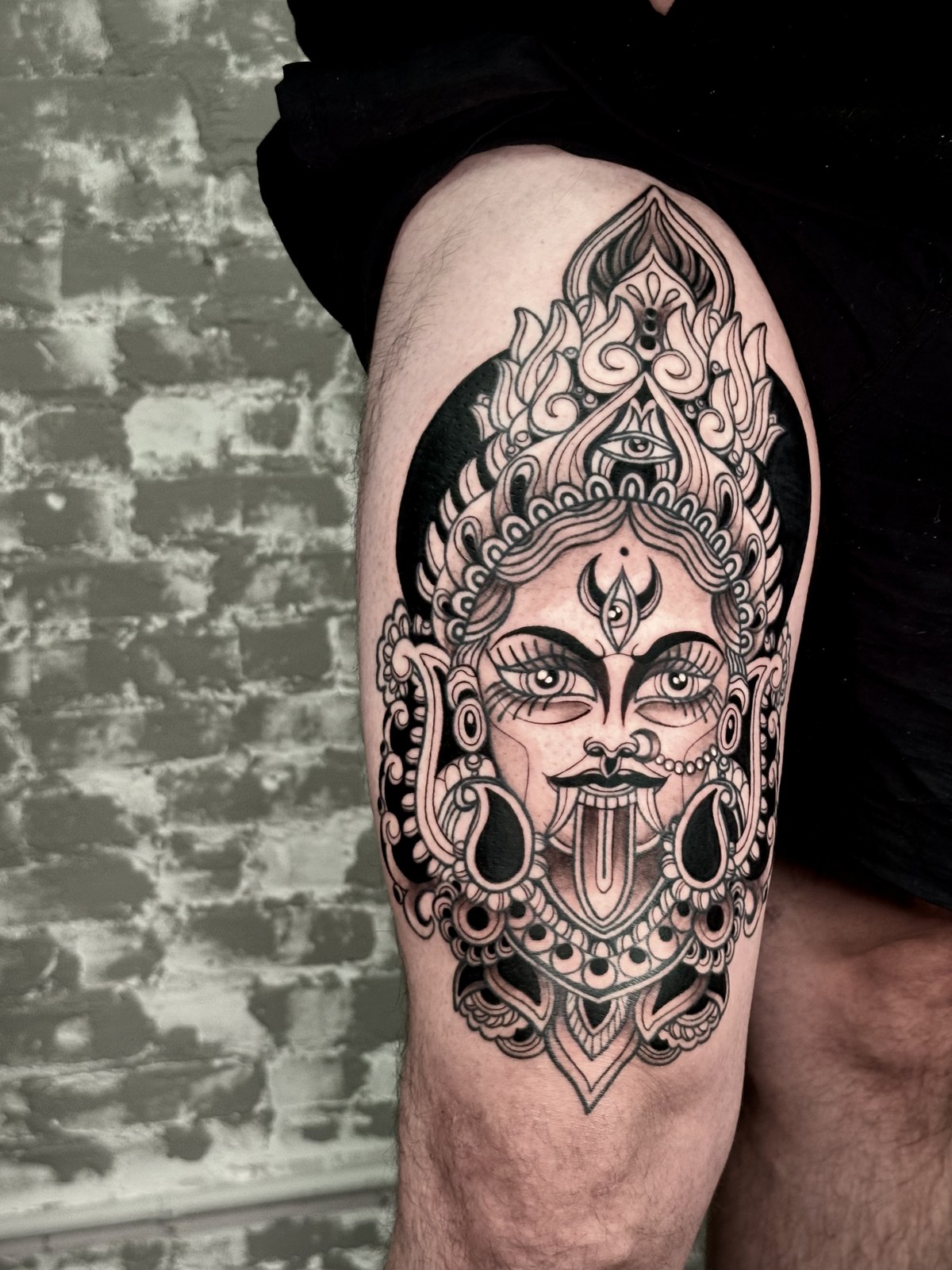 Ornamental goddess thigh tattoo